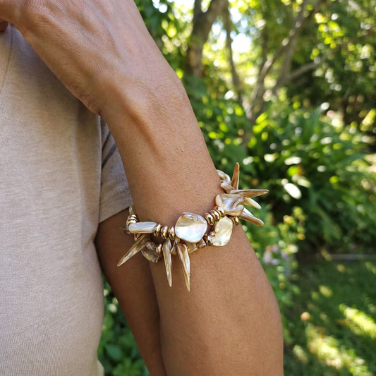 The Current iridescent shell bracelet on wrist by Designs by DRL